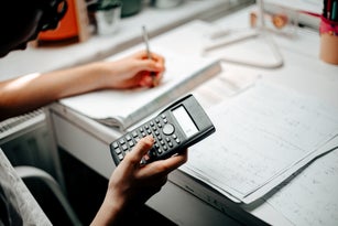 medium shot of teenager studying and doing homeworks