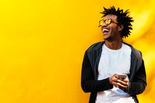 Portrait of handsome afro man using his mobile.