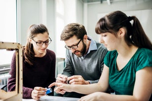 Engineering Students Listening To Tutor During Teaching Session