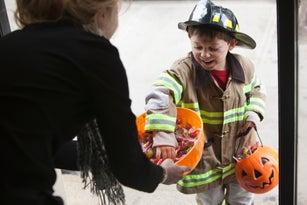 Caucasian boy trick or treating on Halloween