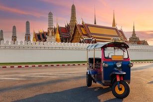 Tuk Tuk Taxi or Three-Wheel Vehicle with Wat Phra Kaeo background