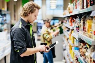 Supermarket Employee Performing Stock Check