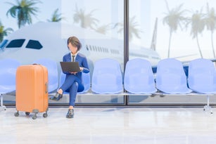 Stylized Character Businesswoman Working on Laptop at Airport