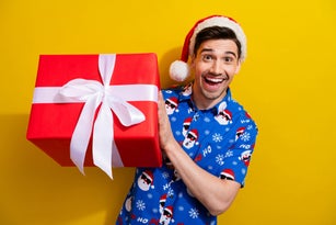 Photo of traditions midnight happy new year man received santa claus surprise gift box wear red hat isolated on yellow color background