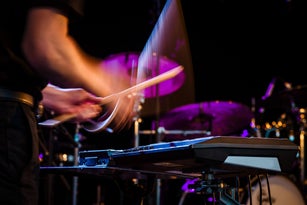 Drummer playing rock music on concert