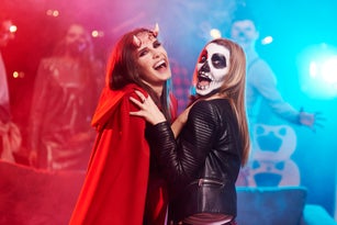 Women in creepy costumes dancing at Halloween party