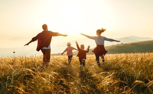 Happy family: mother, father, children son and daughter on sunset