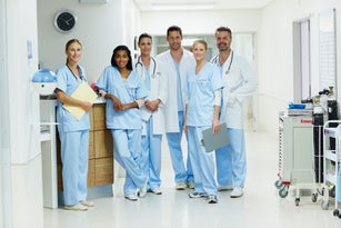 Confident healthcare workers standing in hospital