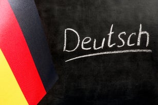 Flag of Germany and a chalkboard with the inscription Deutsch.