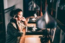 Woman relaxing to old-school vinyl records with headphones in cozy modern ambient lighting