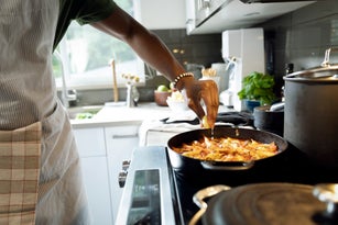 Close up of man cooking in kitchen