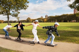 Friends skateboarding in a park
