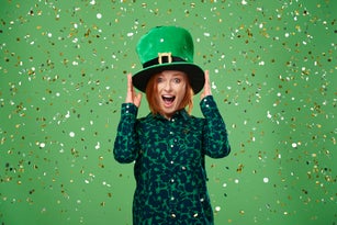 Screaming woman with leprechaun's hat under a shower of confetti
