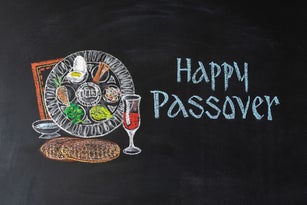 Passover plate and traditional food for Passover (Pesach) on chalkboard. Passover dinner, seder pesach.