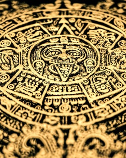 An Aztec or Incan or Mayan gold coin featuring Mayan calendar