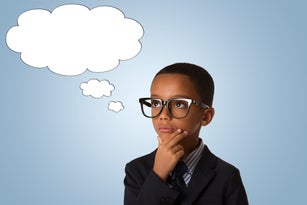 concept of confusion, inspiration and solution- pensive little african american boy in business suit and in glasses with empty speech bubble