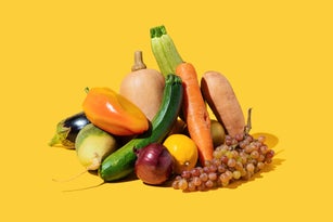 Variety fresh of organic fruits and vegetables on yellow background. Healthy food, clean eating, diet and detox concept .