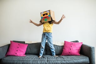 Young girl wearing robot costume at home