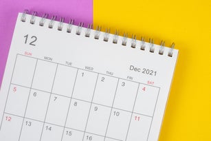 Calendar desk 2021 on December month, Top view calendar planning on colorful paper background.