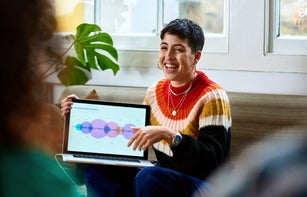 Cheerful young woman with laptop smiling