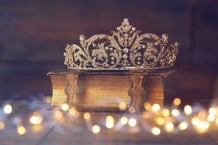 low key image of decorative crown on old book