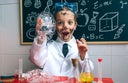 Funny boy chemist with dirty face