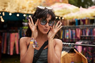 Happy woman puckering while wearing sunglasses