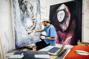 Young Artist working on big painting