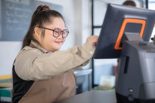 Special needs cashier working in a cafe