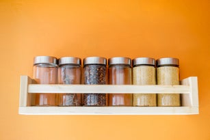 Spices jars on wooden shelf