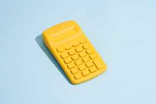 Yellow Calculator On Blue Background