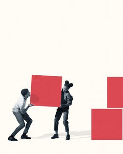 Young man and woman carrying red block