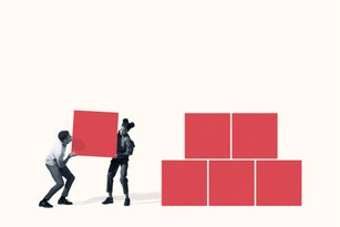 Young man and woman carrying red block