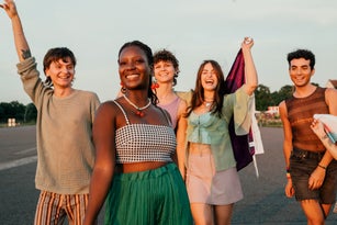 Group of cheerful queer friends at a pride event