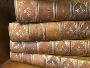 Books Stacked on a Shelf in Natural Light