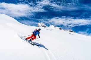 Ski mountaineer off piste downhill on snowy slope