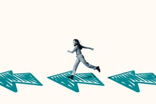 Happy young woman running on turquoise arrows