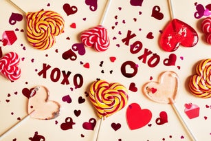 Valentine's day background with heart shaped lollipop and confetti.