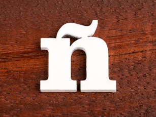 ñ - lowercase letter. Piece in wood