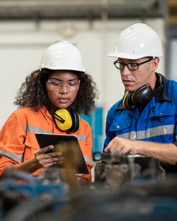 Productivity Improvement of Welding Assembly Lines in Manufacturing Industry. Manufacturing Process Engineers having discussion on welding jig design data to improve and reduce defect loss of work piece in welding process.