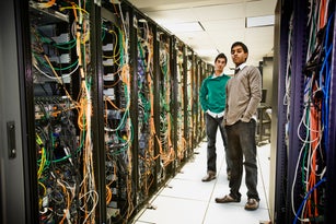 Businessmen standing together in server room