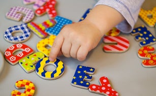 Toddler playing with alphabet letters