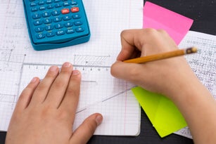 Schoolboy Hands with Ruler Drawing on White Paper. Mathematics Concept.