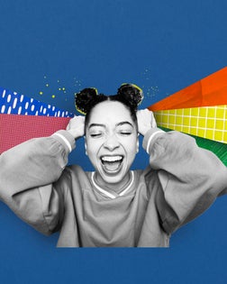 young person laughing holding shapes