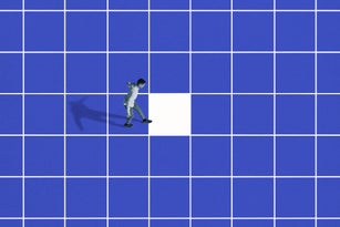 Side view of young man walking on blue grid