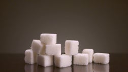 Pile of sugar cubes on isolated background. Stock footage. Pile of sugar cubes changes in number on isolated background. Sweets in large quantities are harmful to health. Sugar and sweets are 21st century addiction