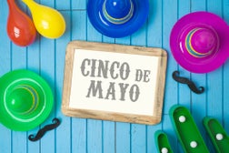 Cinco de Mayo holiday background with Mexican cactus, photo frame and party sombrero hat on wooden board