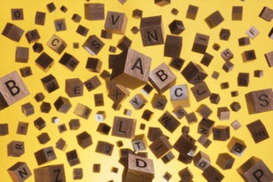 Abstract Background of Wooden Text Alphabet Block Floating in the Air on Yellow Background
