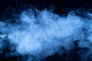 Abstract blue smoke on a dark background. Blue smoke background