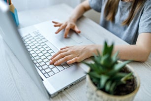 Children's hands are typing on the keyboard